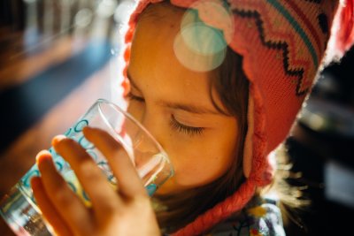 A child having a drink. Credit: Johnny McClung | Unsplash