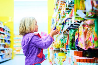 Child looking at confectionery in a store. Credit: Petr Bonek | Shutterstock
