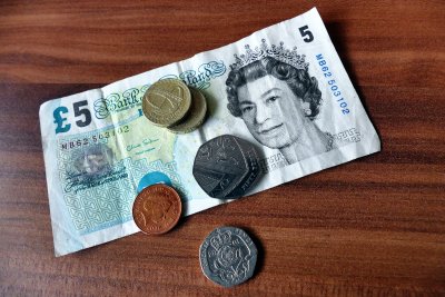 Five pound bank note with coins. Credit: Anthony | Pexels