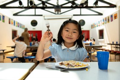 Girl enjoying school lunch. Credit: School Food Matters