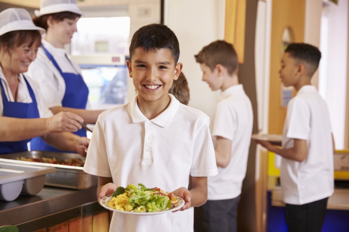 A young boy with a school lunch. . Credit: Monkey Business Images | shutterstock