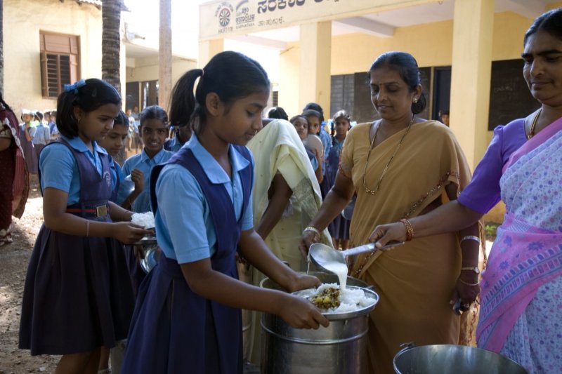 Children enjoying their mid-day meal program in India.