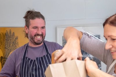 Baker and customer. Copyright: Batches Bakery CIC