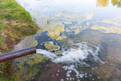 Pipe water flows into the river causing environmental contamination.. Copyright: Alexmalexra | shutterstock