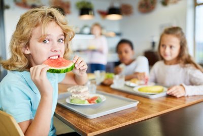 Child eating melon. Credit: Robert Kneschke | Shutterstock