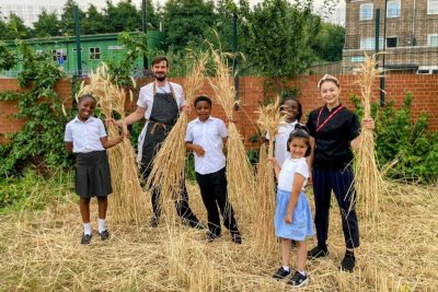 Tom, Coral and children harvesting wheat. Copyright: Hackney School of Food