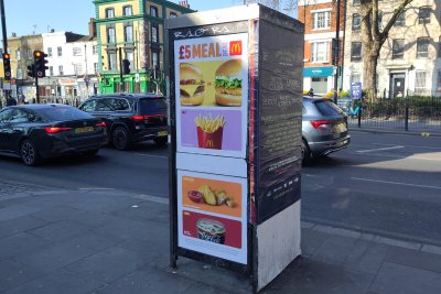 Unhealthy food advert on a roadside telephone box. Credit: Fran Bernhardt