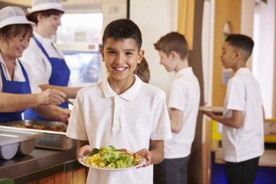 A young boy with a school lunch. . Credit: Monkey Business Images | shutterstock