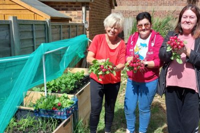 Community growers with their radish harvest. Credit: Your Planet Doctors