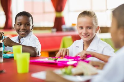 Children having lunch during break time in school cafeteria. Copyright: wavebreakmedia | Shutterstock