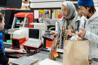 A couple pay for their shop at the supermarket. Credit: Jack Sparrow | Pexels