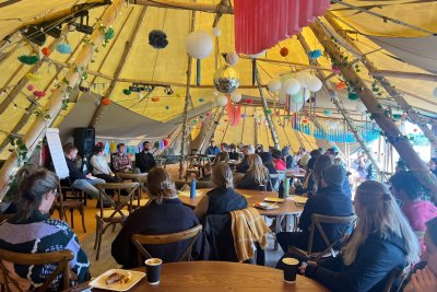 A gathering of people in a tent at an Emergent Generation event. Credit: Emergent Generation