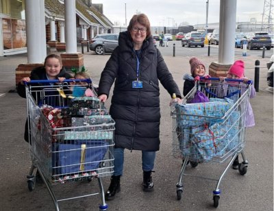 Headteacher Sarah Smith and pupils delivering Christmas parcels for local families in Blackpool. Credit: Sarah Smith