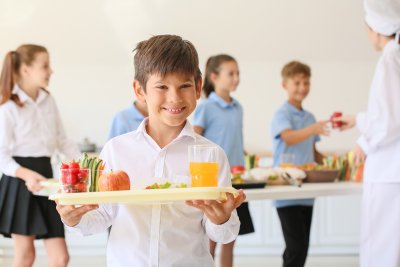 A young boy with a school lunch. Copyright: Pixel-Shot shutterstock