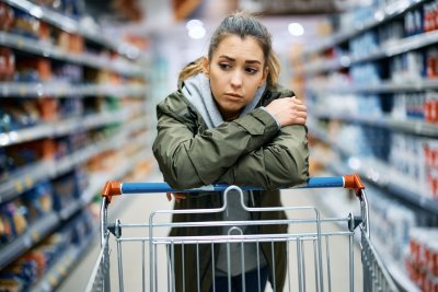Young woman in supermarket with worried look.. Copyright: Drazen Zigic | shutterstock
