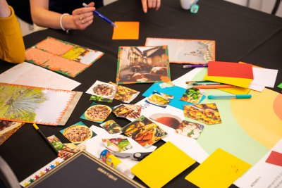 pictures of food and coloured paper scattered on a table