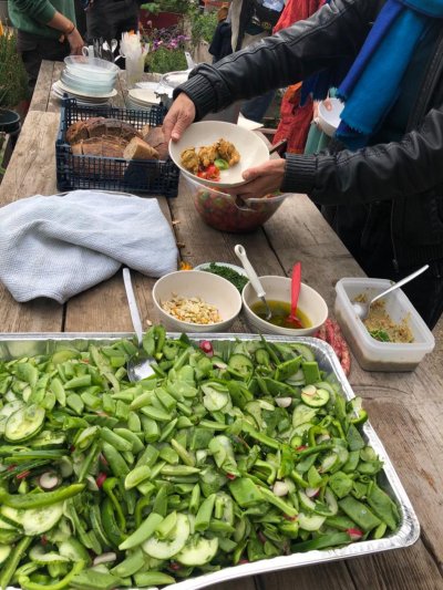 Serving up their community meal with fresh produce harvested from the garden. Copyright: Fi McAllister