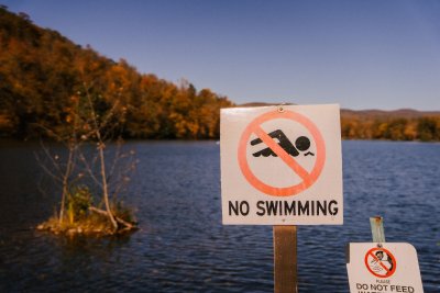 No swimming sign near water - only 14% UK rivers have 'good ecological status'. Credit: Marta Wave, Pexels