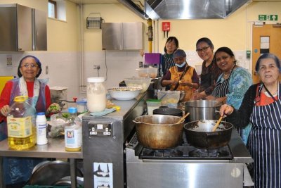 Chef Sumathi leading the kitchen volunteers in the Diwali feast preparations. Credit: Josiah Braithwaite Community Garden