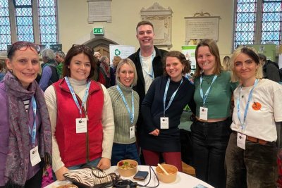 Seven people at a conference standing and smiling at the camera. Credit: How Farming Can Cool The Planet