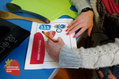 Someone signing the Fizz Free Feb pledge. Credit: Edinburgh Community Food