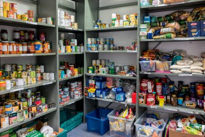 Storage shelves in a local church food bank warehouse. Credit: HASPhotos / Shutterstock