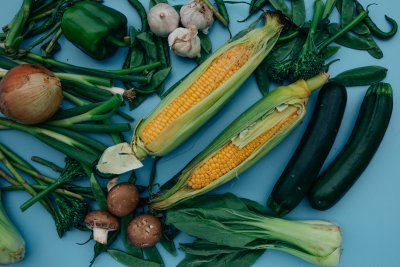 Vegetables and corn on blue surface. Credit: Viktoria Slowikowska | Pexels