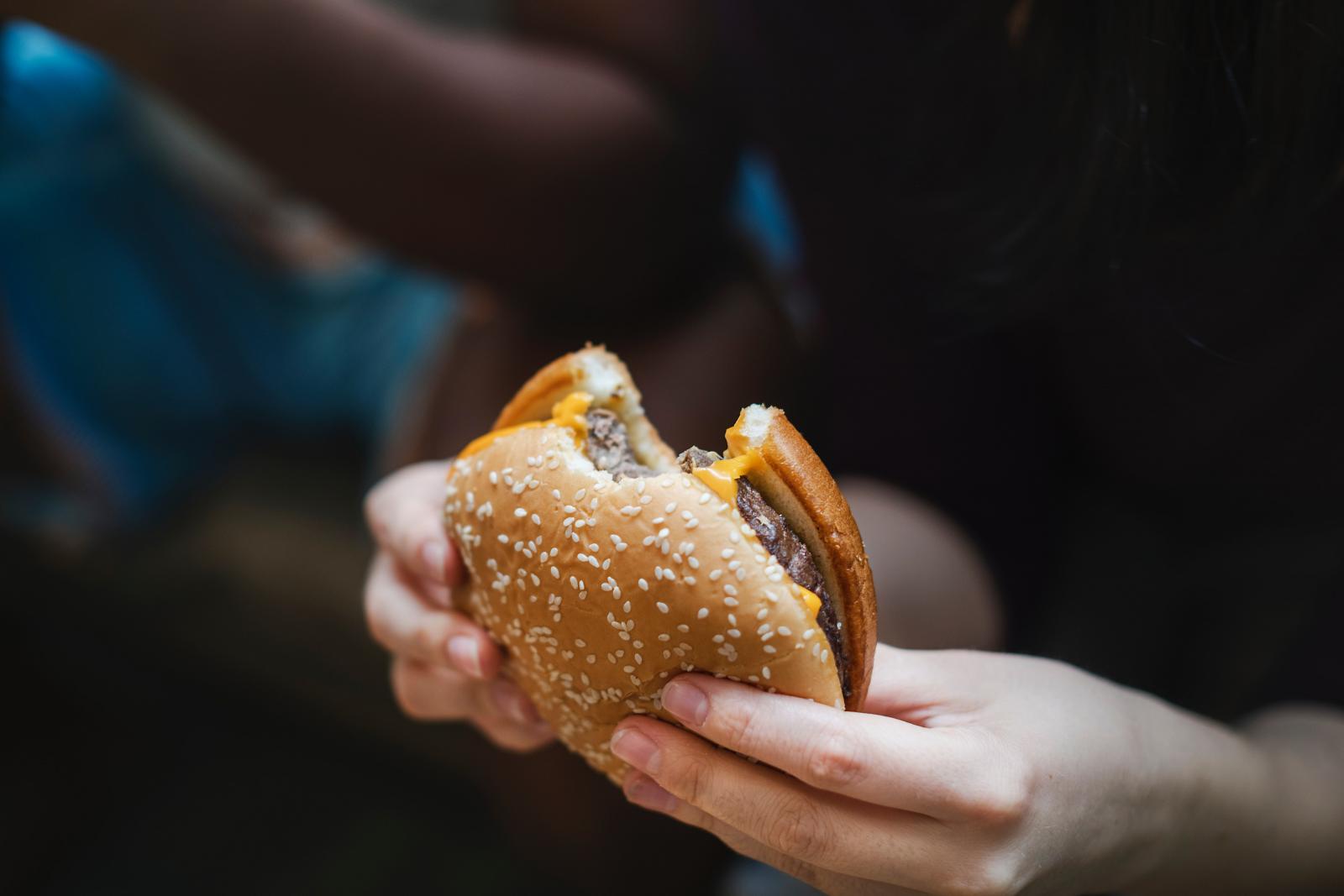 Teenager eating a burger. Photo credit: Pexels