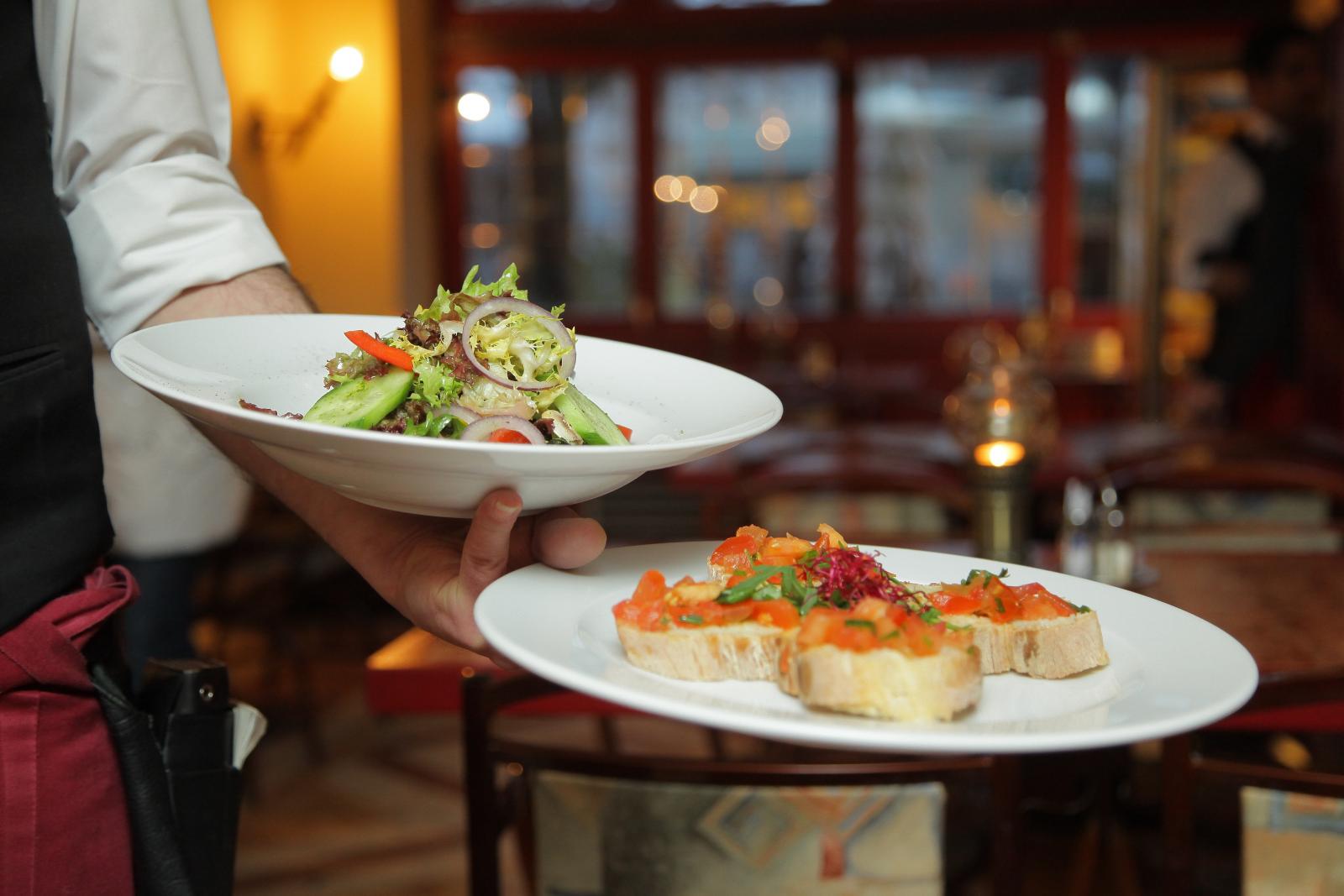 Waiter serving food. Photo credit: Pexels