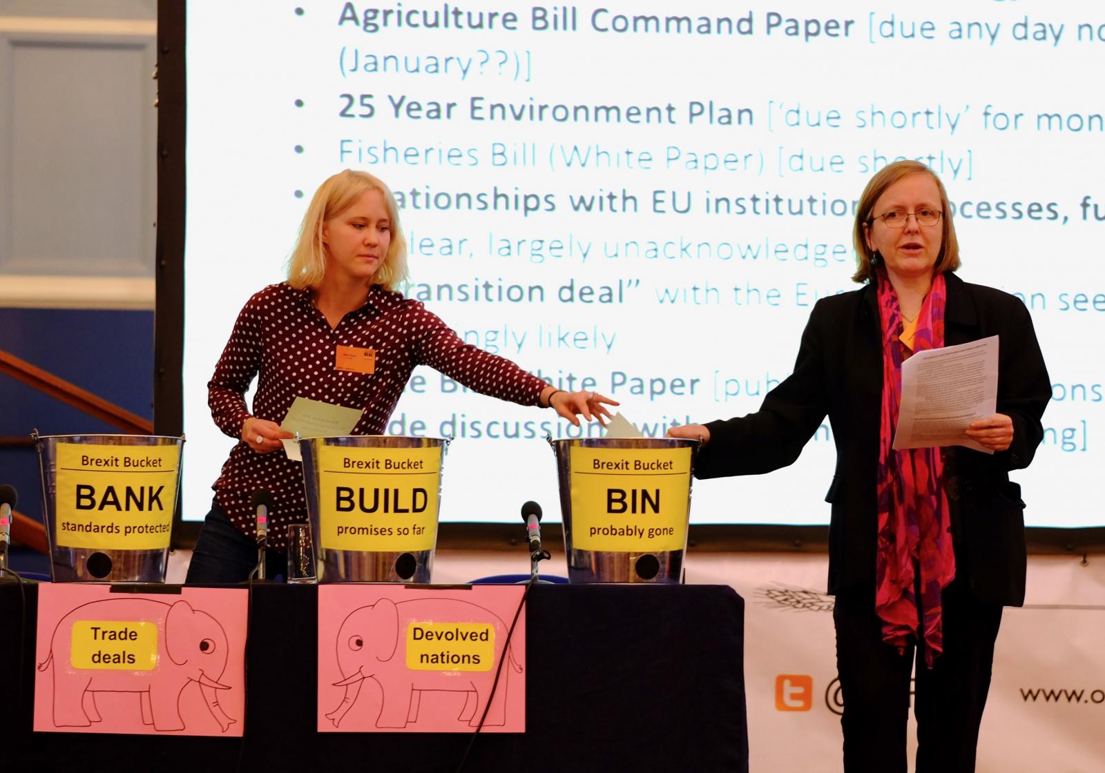 Sustain's Abbi Kent (left) and Kath Dalmeny (right) explain the Brexit state of play with the aid of three buckets, Oxford Real Farming Conference main stage, January 2018