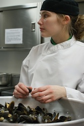 Young chef prepares mussels