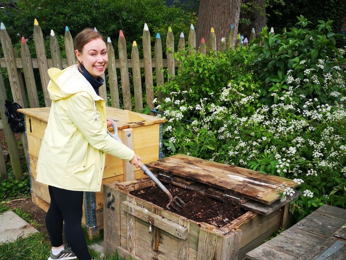 Volunteer Cornelia turning compost at a community compost site, image credit Brighton & Hove Food Partnership