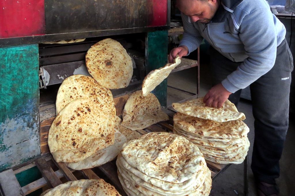 Fourteen thousand years later...a flatbread baker in Jordan by David Stanley CC-BY-SA-2.0