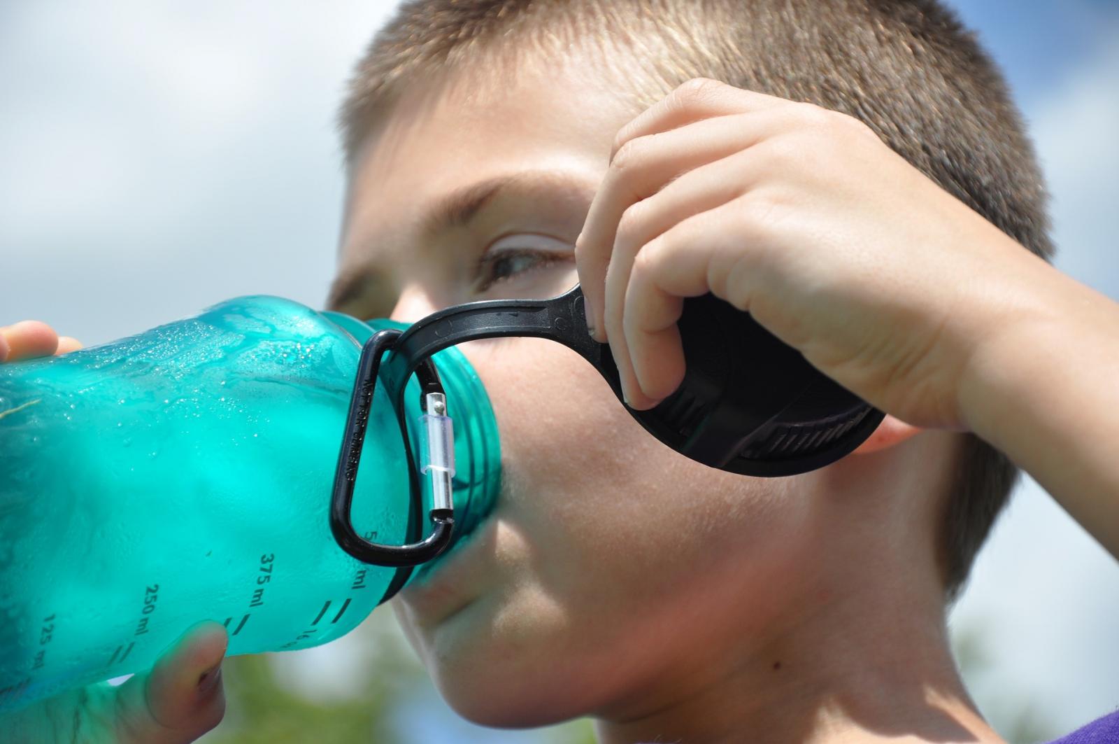 Boy drinking from a reusable bottle. Photo credit: Pixabay