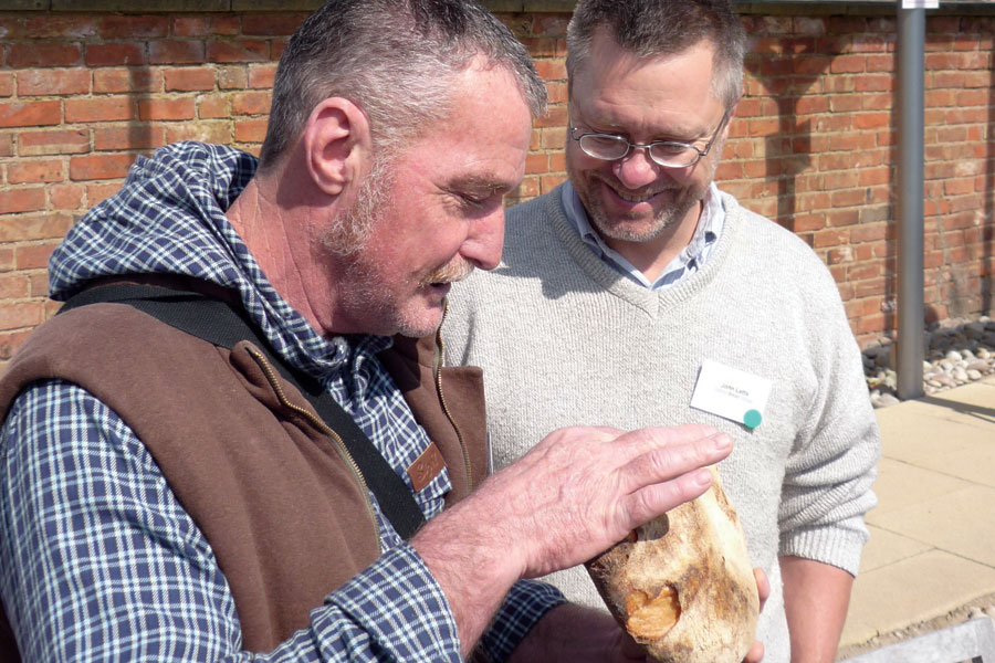 John Downes (left) sharing a loaf with John Letts. Photo by Chris Young / realbreadcampaign.org CC-BY-SA 4.0
