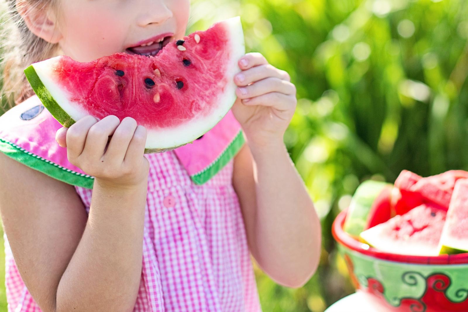 Child eating a watermelon. Photo credit: Pexels